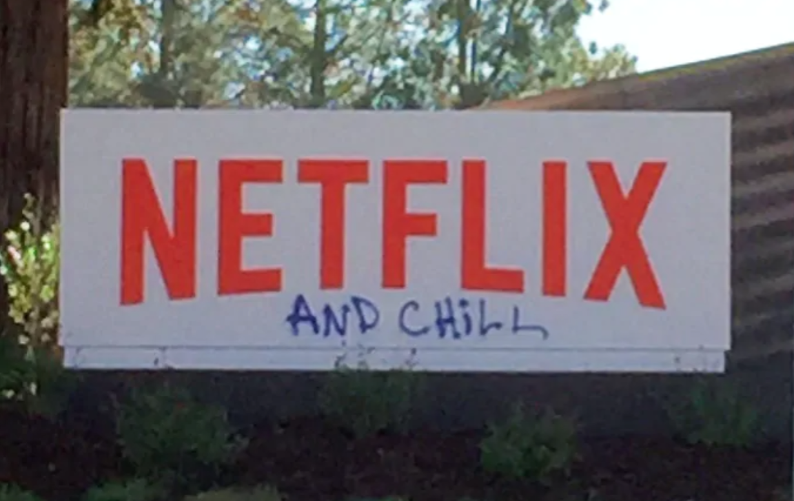 Netflix's office building with spray paint that reads 'and chill' under the logo