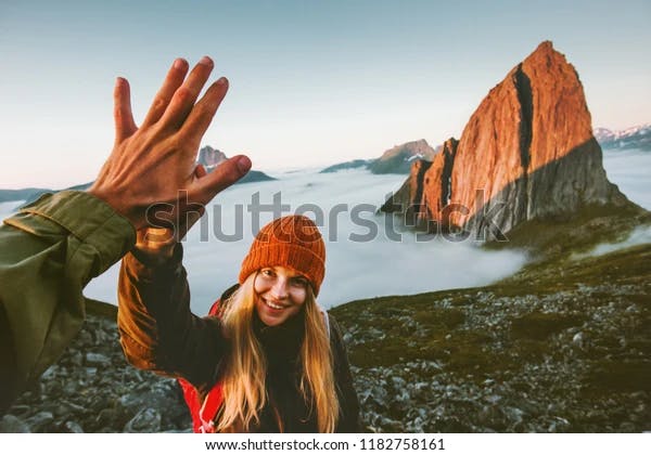 Couple giving a high five on a mountaintop