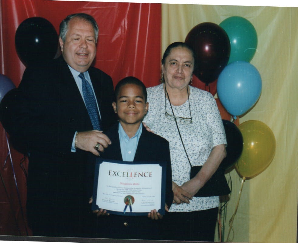 Dío as a child, being recognized for his academic excellence